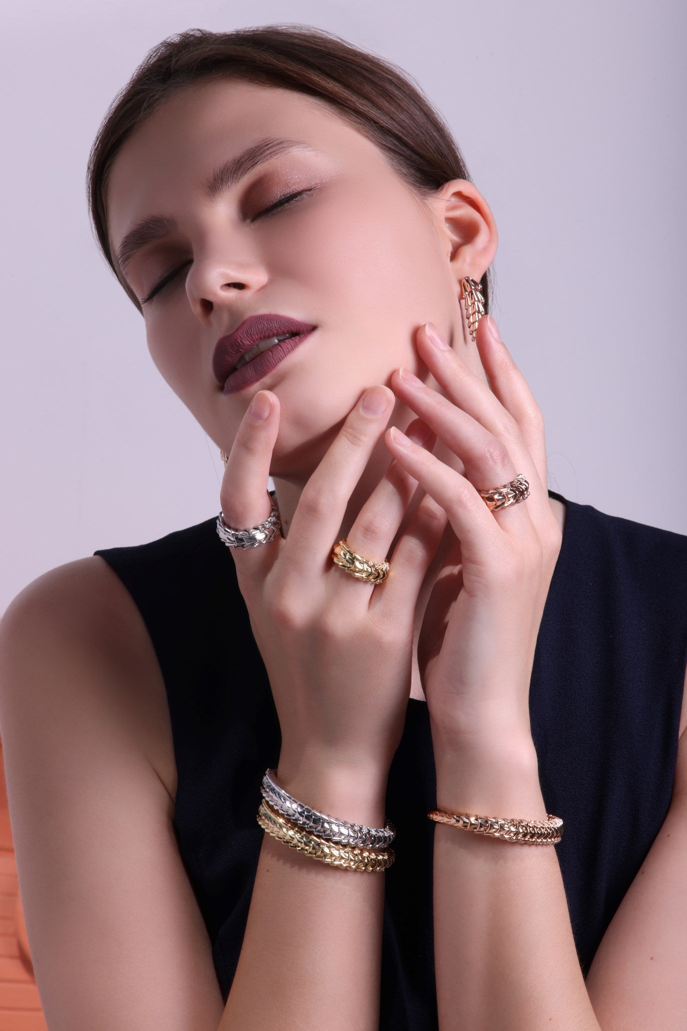 Date Palm Collection styled on model: 18K gold earrings, expandable bracelets & rings in rose, white & yellow gold by Tariq Riaz